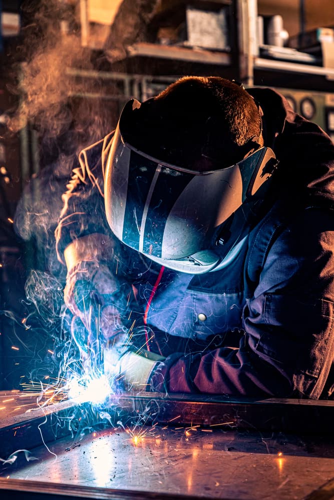 Certified welder fabricating steel pipe in the S&S Mechanical Sparks shop