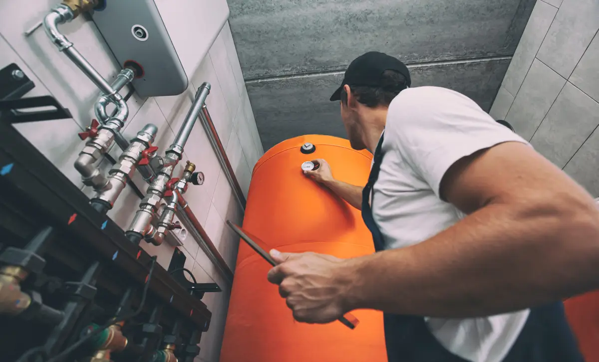 Technician working on a water heater in a Reno home